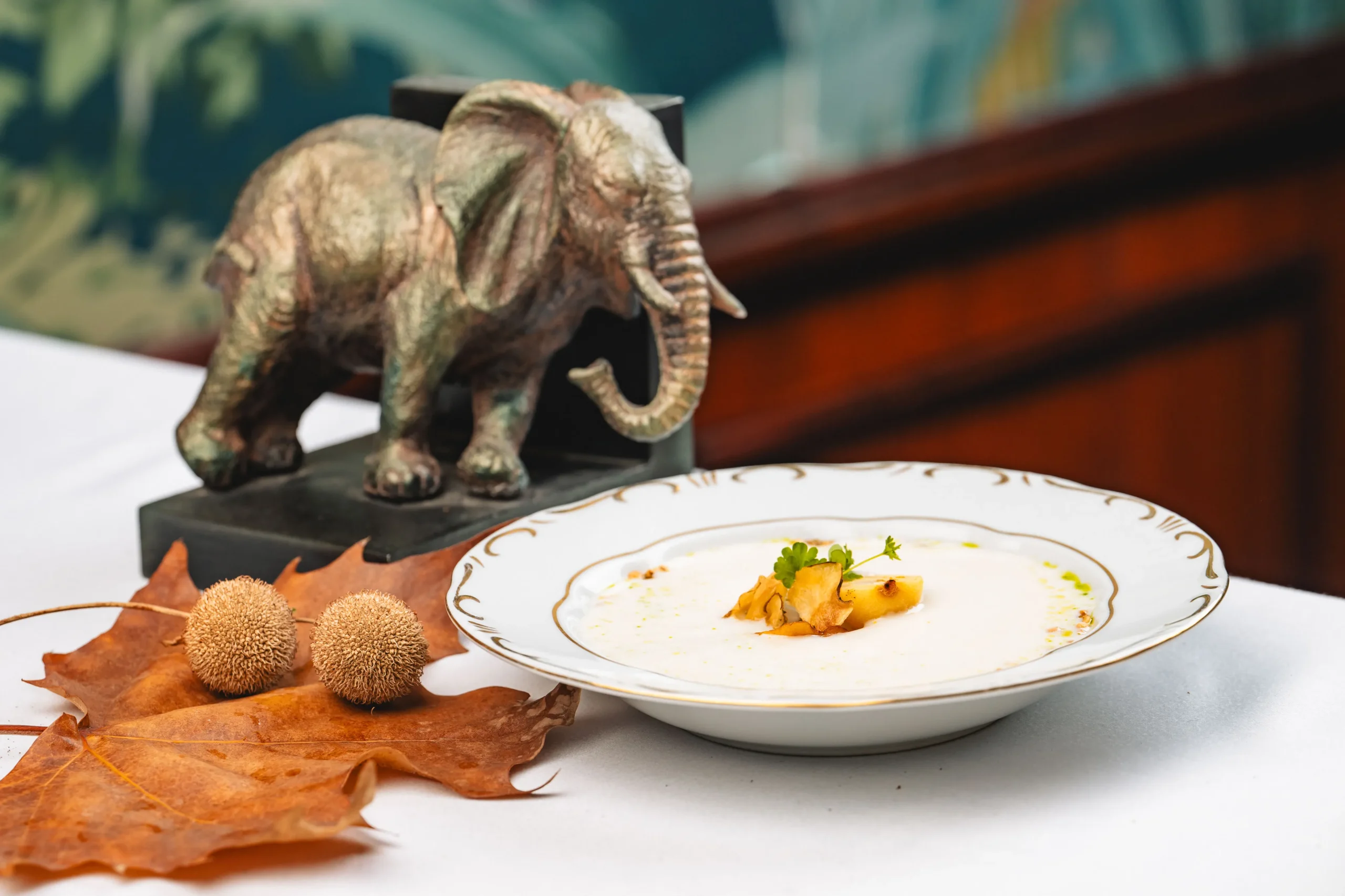 Jerusalem artichoke cream soup with pickled pear and puffed barley, served in a deep plate